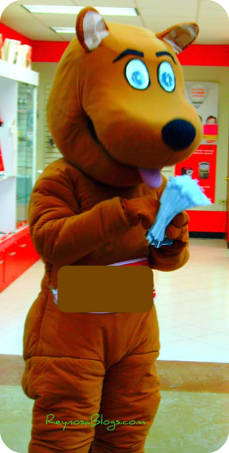the mascot in the store is holding soing in his hands