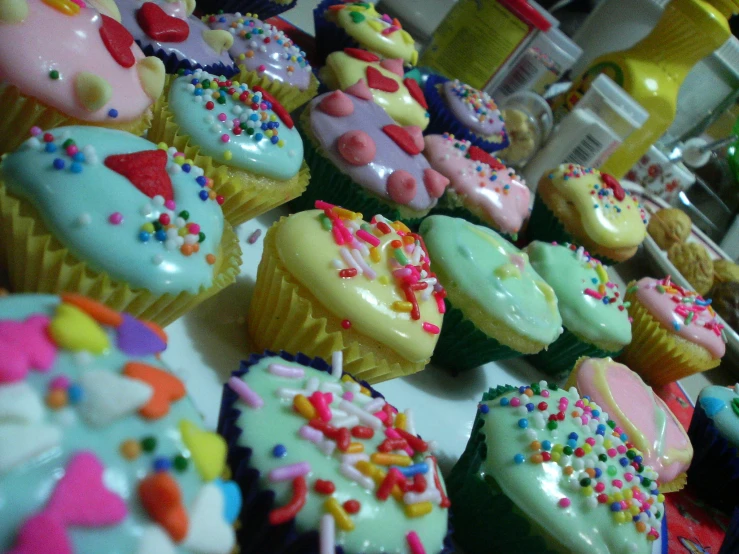cupcakes with different shapes and designs are displayed for sale