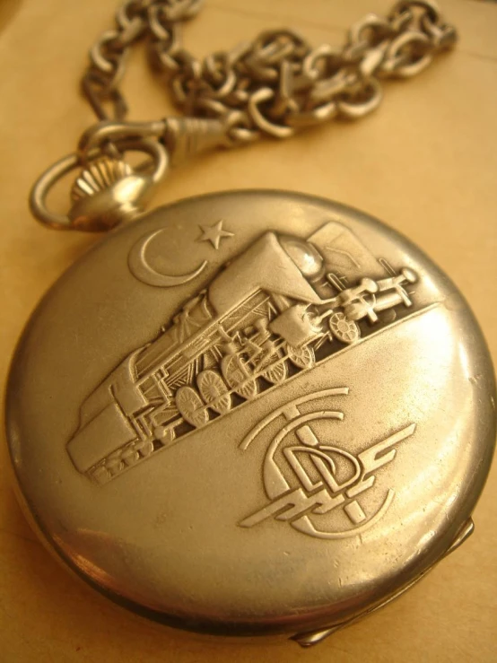a close up of a pocket watch with a chain