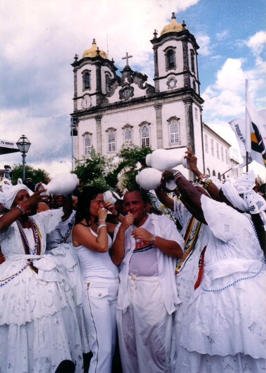a group of women dressed in white dress dancing