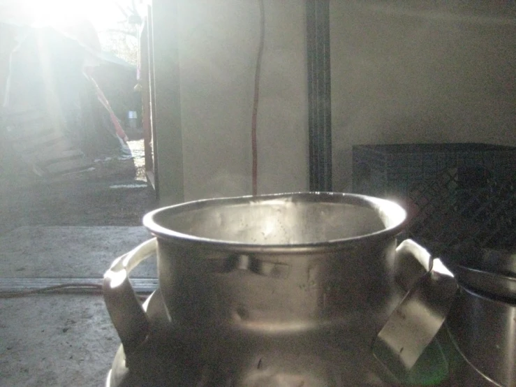 a large silver pot sitting on top of a counter