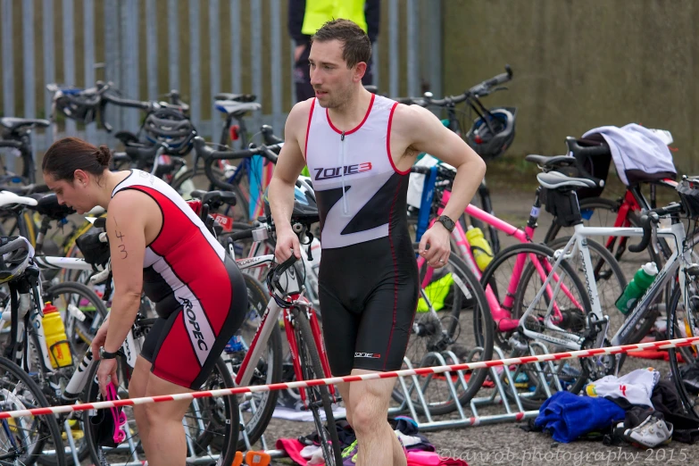 a group of bicyclists wearing their trisuits at a bicycle park