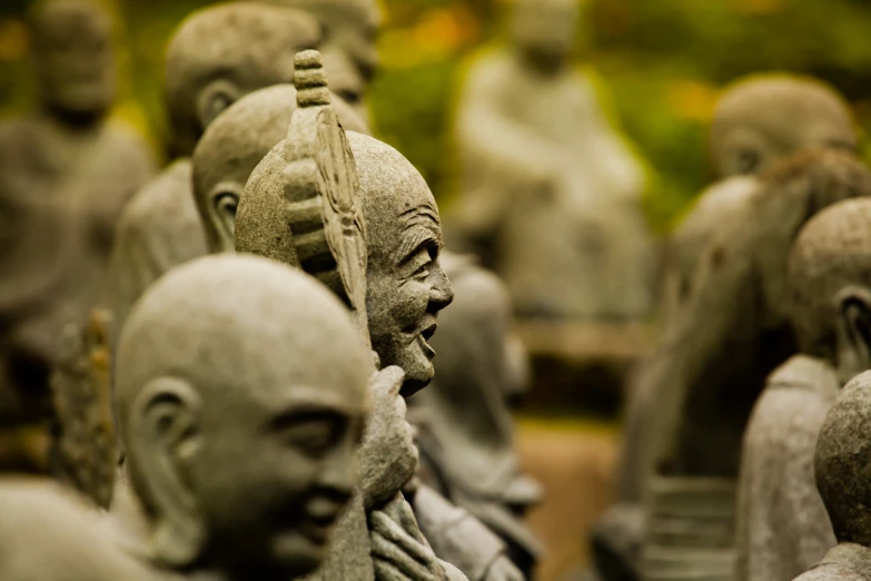 a group of statues depicting different people in a line