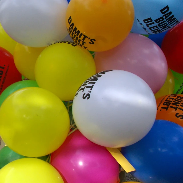 a pile of balloons with labels and numbers