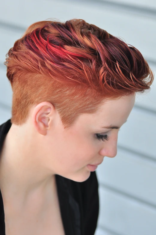 a woman with red hair that has red streaks