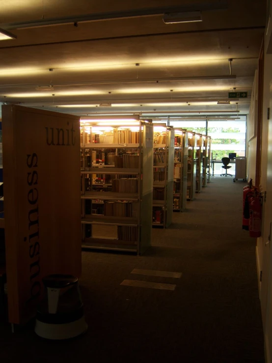 a number of books are stacked on shelves in a liry