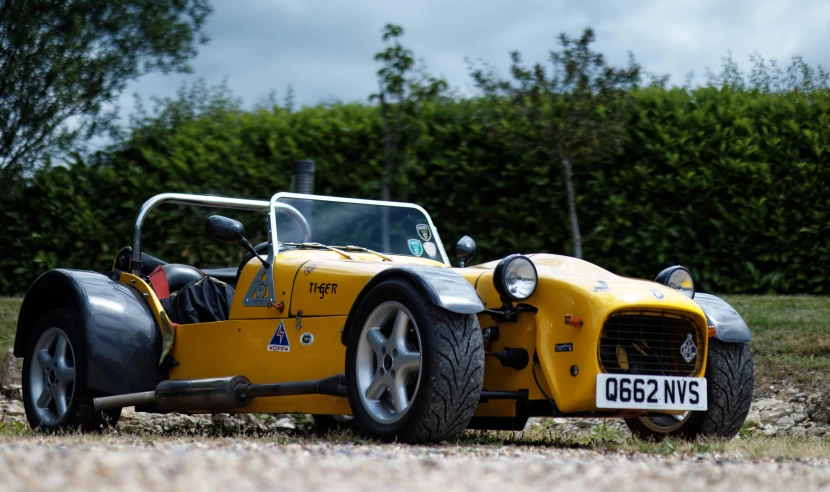 an old yellow motorcycle with a buggy on the front