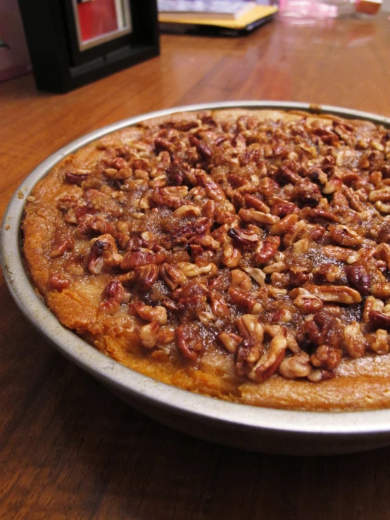 an open pie is sitting on the table with other ingredients