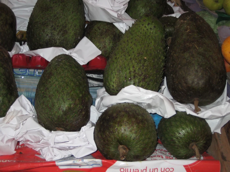 large fruits are stacked in a pile on the table