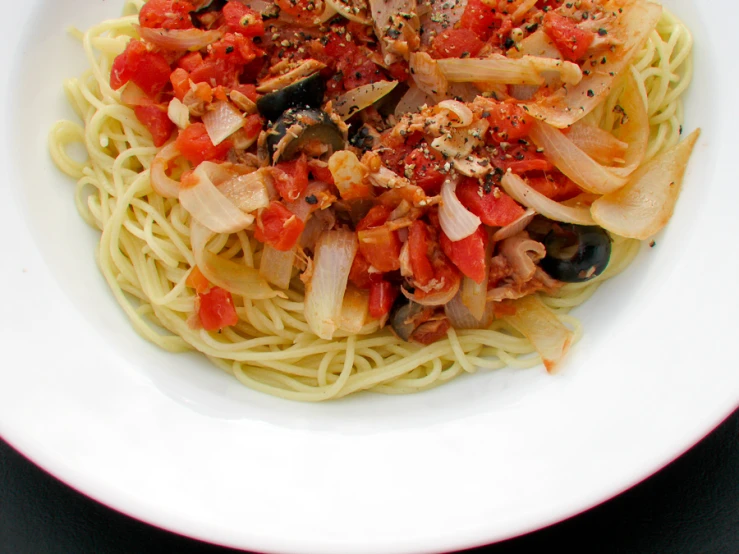 pasta with tomato sauce and mushrooms served in white bowl