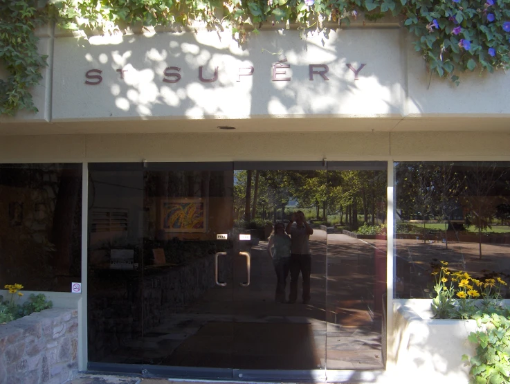 the entrance to a building with two people taking pictures