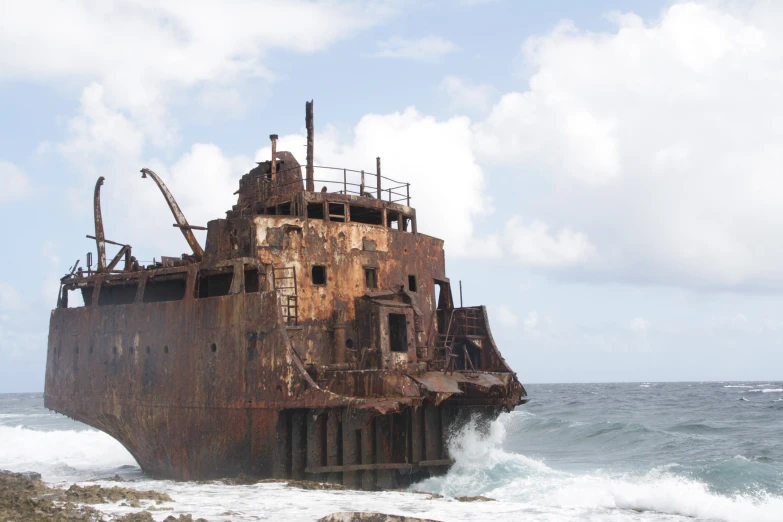 an abandoned rusty boat washed up on shore