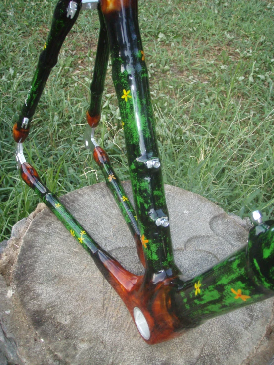 a glass sculpture is on a rock in the grass