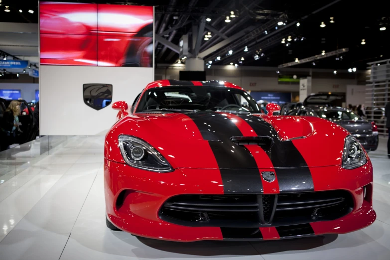 a red sports car with black stripes on it
