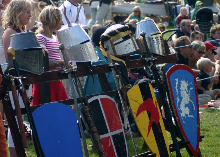 a group of people standing in front of knights on wooden shields