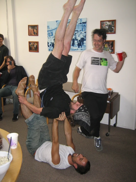 a group of men playing with an object in the air