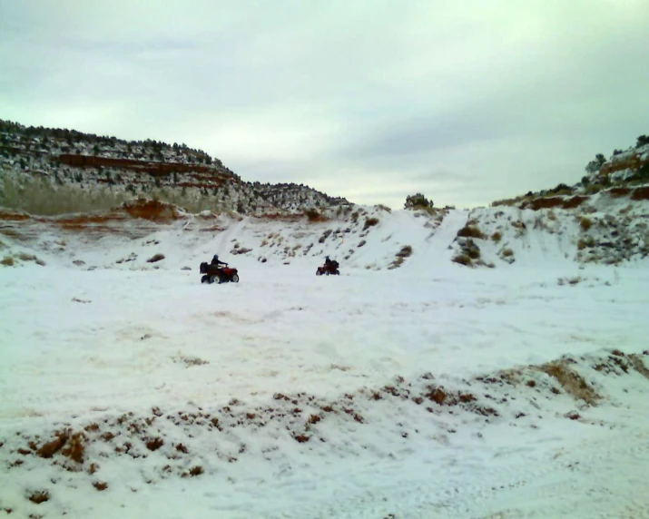 three people riding horses through the snow on horseback