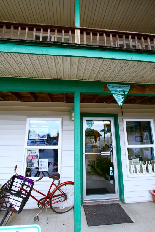 there is a small storefront with a bicycle parked outside of it