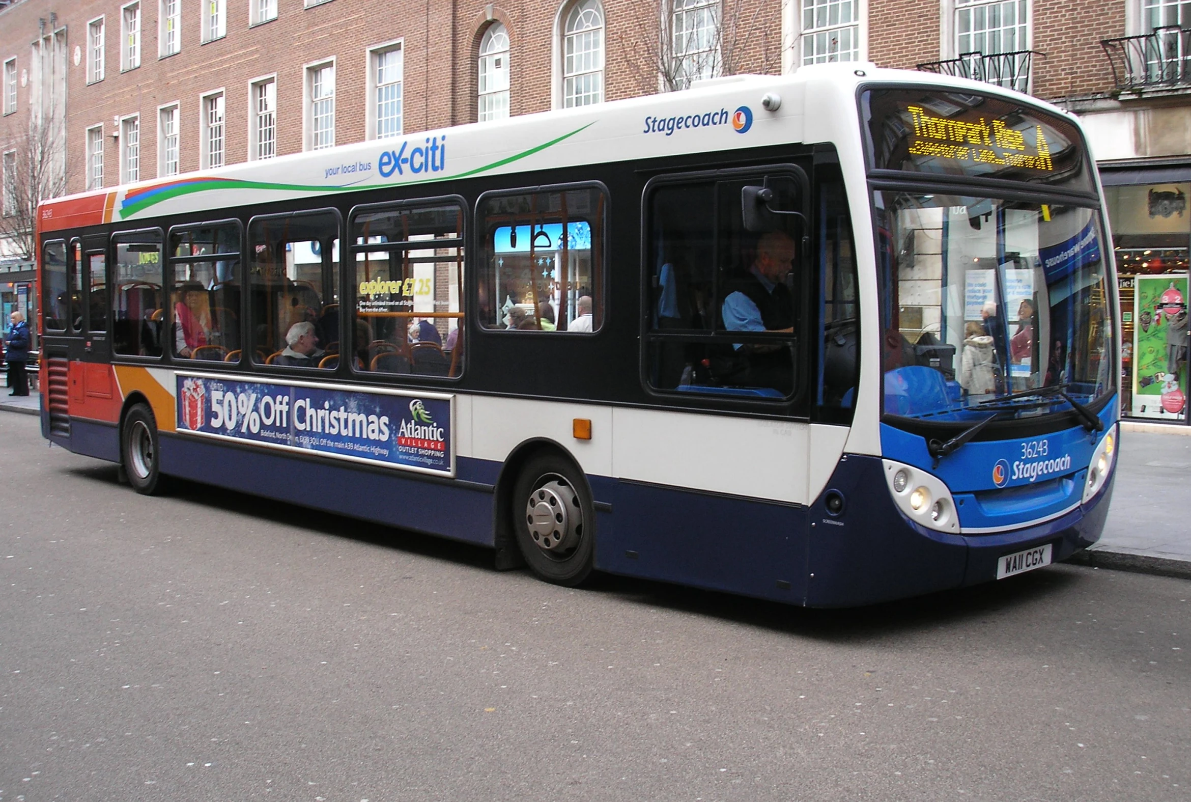 a bus sits parked next to the side of a street