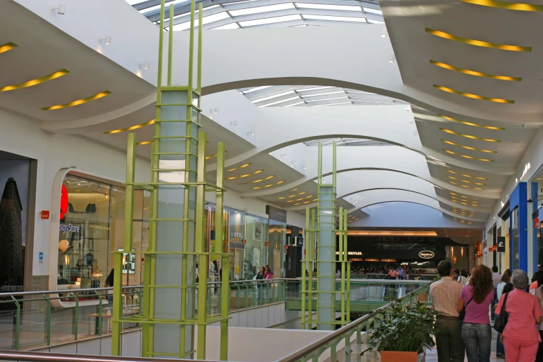 a group of people walking around a mall looking at soing