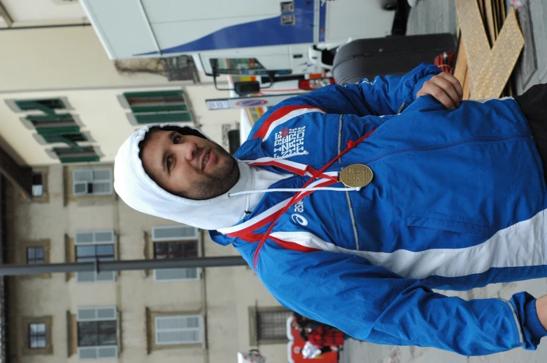 a man with medals and wearing a jacket in front of a building