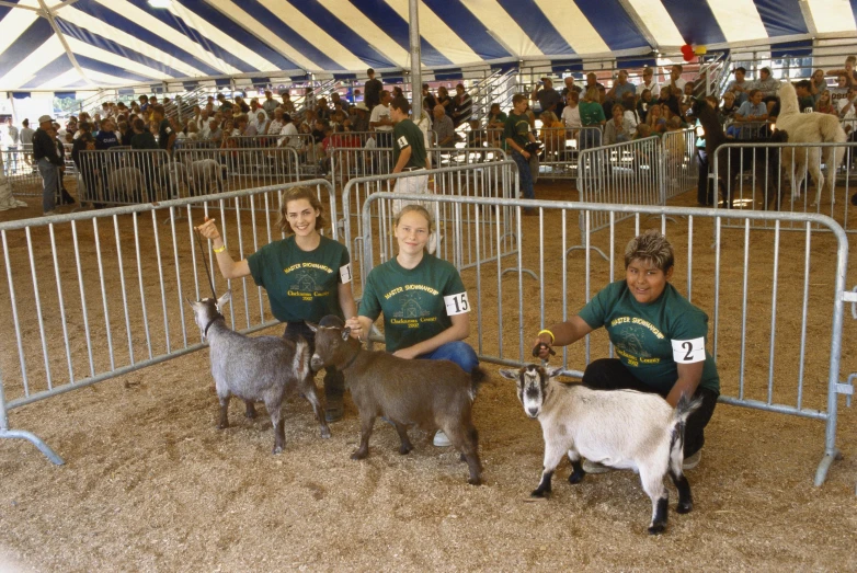 young people are posing with their small animals