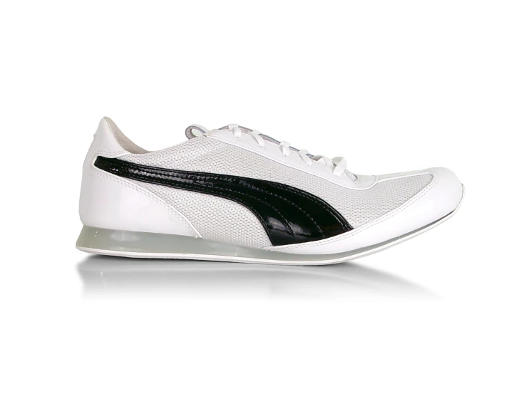 a women's white and black shoe with the logo puma
