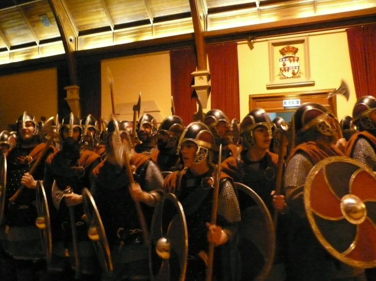 a group of people wearing costumes and helmets, standing in a row