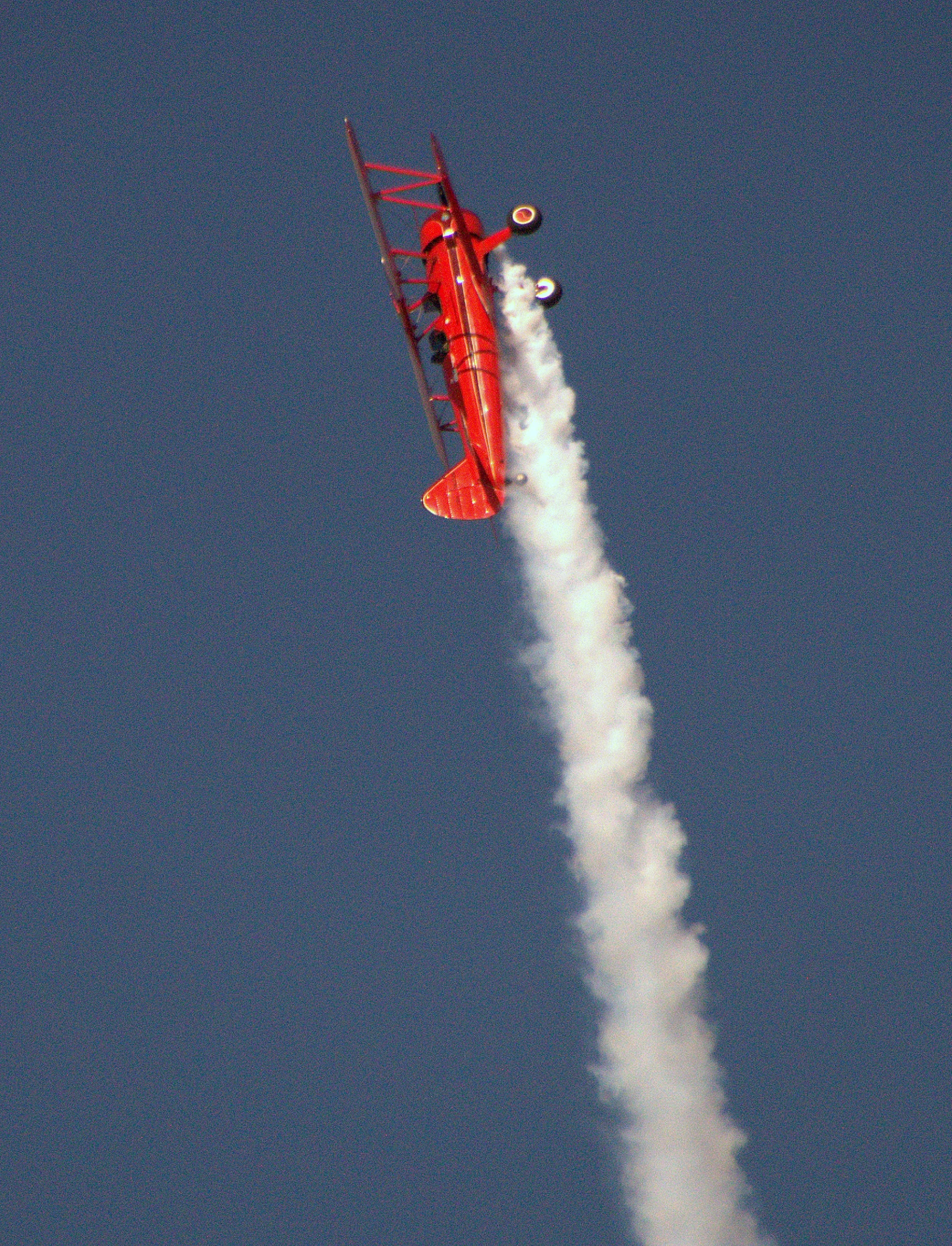 an airplane flies in the sky and shoots smoke