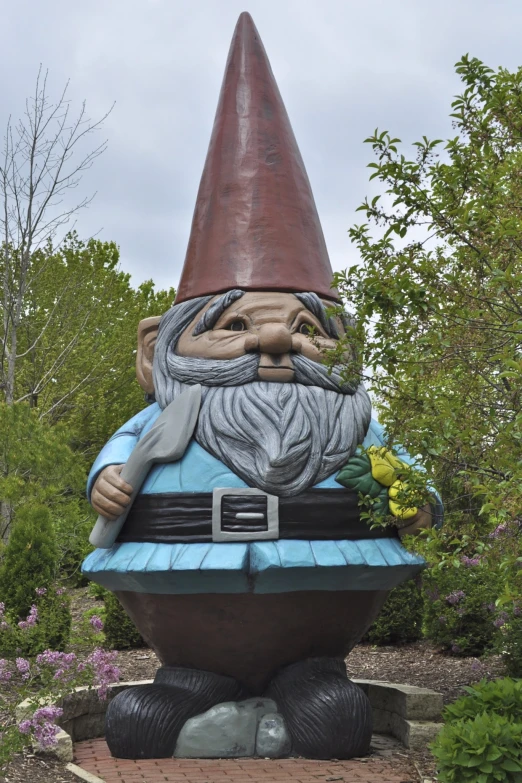 a large gnome statue is sitting on a path