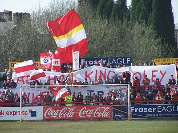 fans at a soccer match in front of the gates