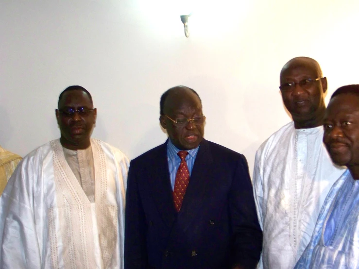 several african businessmen in suits pose for a picture