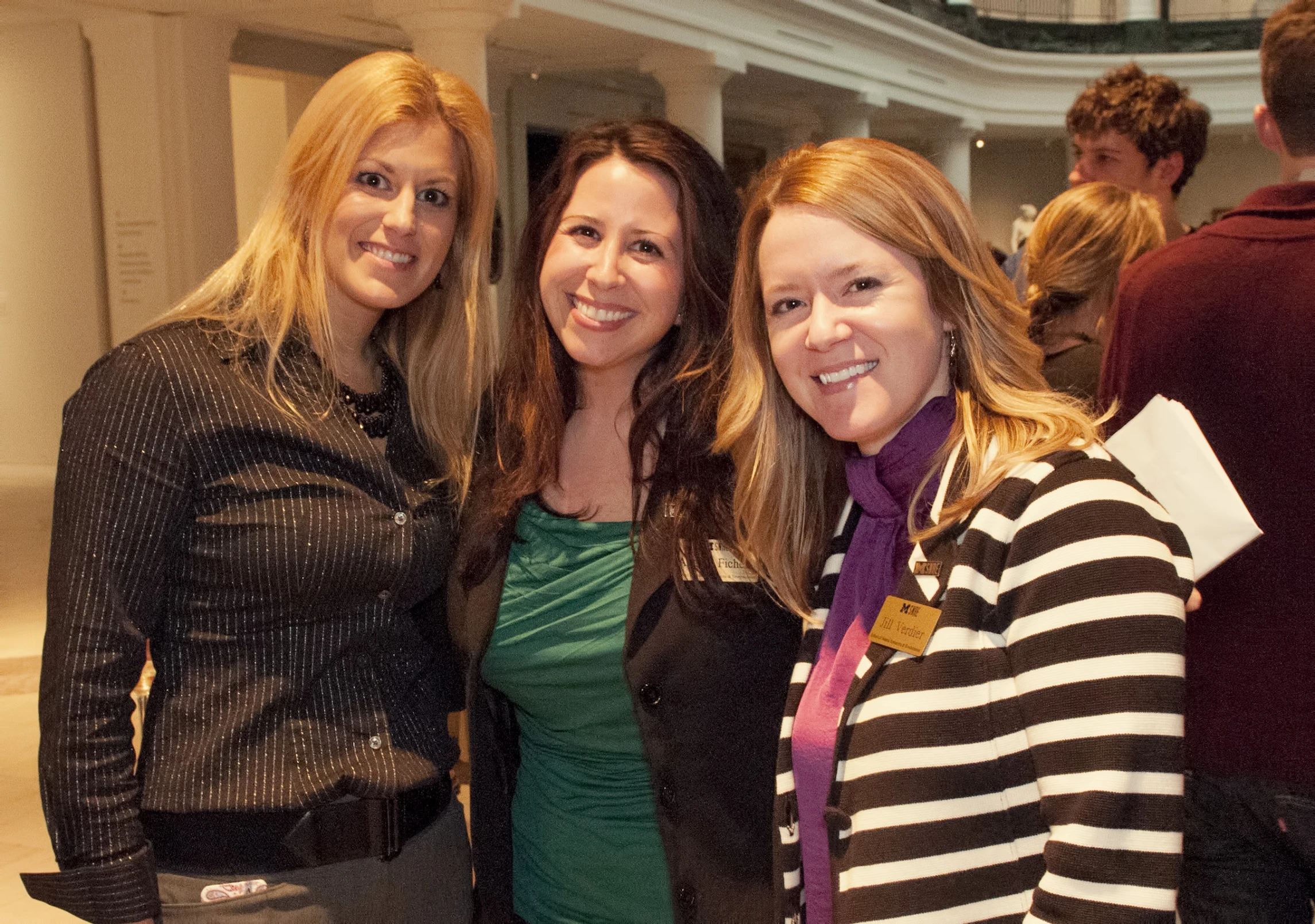 three women standing next to each other near each other