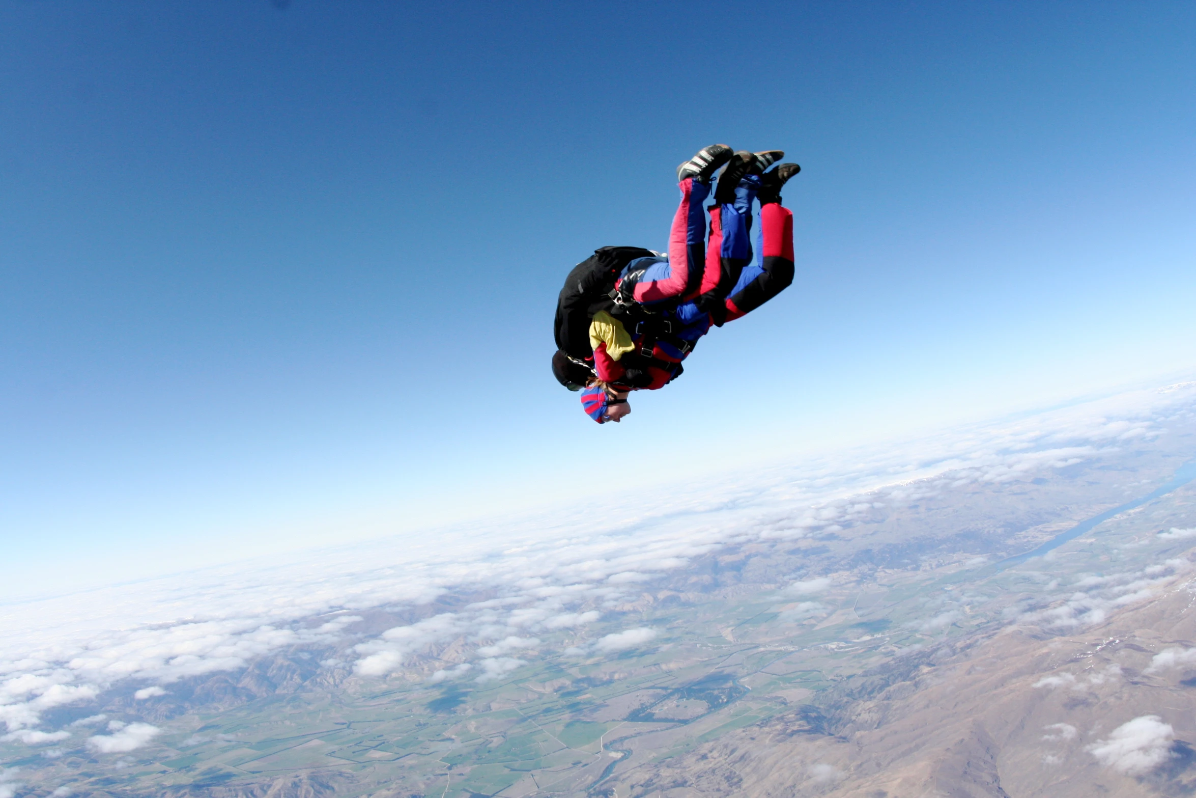 person in a red and blue suit on a parachute