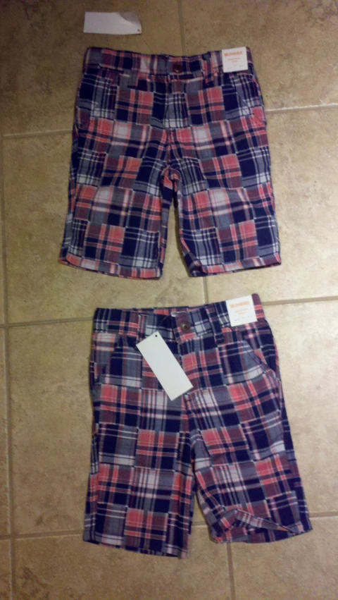 a pair of plaid shorts are laid out on the tile
