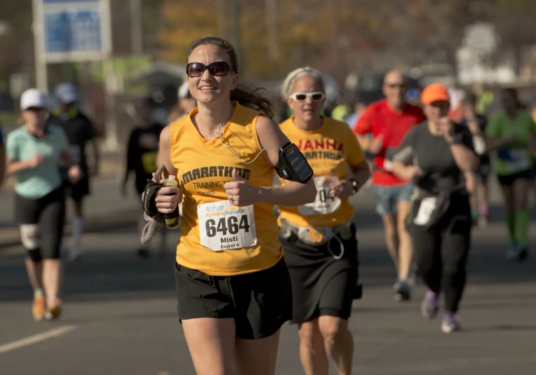 a man and woman are jogging in the street