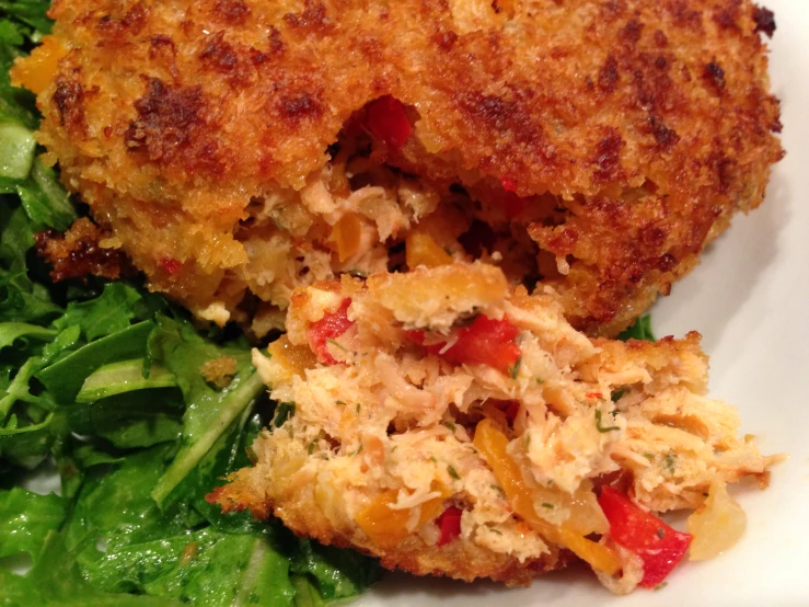 a cooked crab cake on top of a pile of lettuce