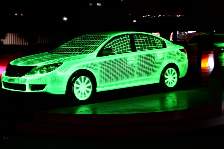 a large car is shown in the dark on display