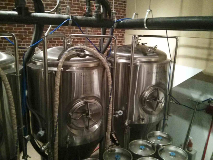 large silver tanks with some small metal containers