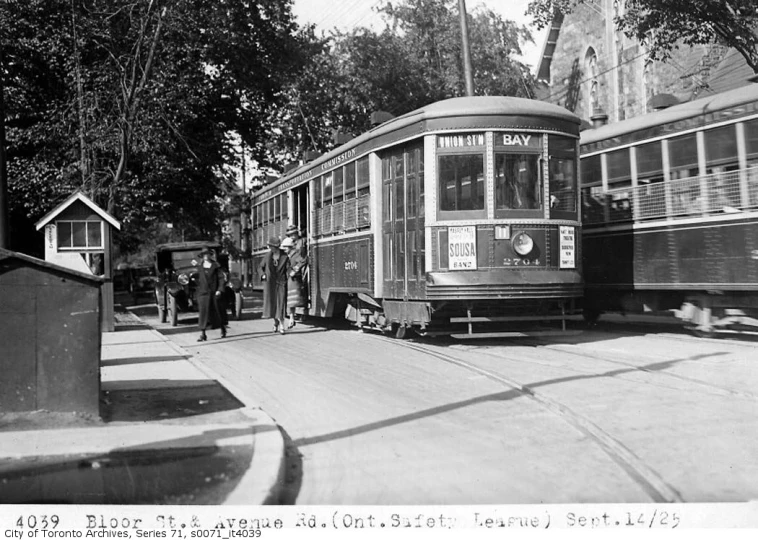 old trolley car at an outdoor station in an urban area