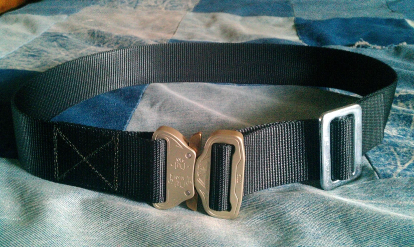 a tan belt with a pair of ss buckles on it