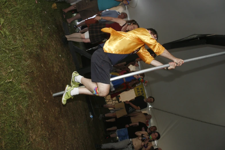 a man holding up a pole at a music festival