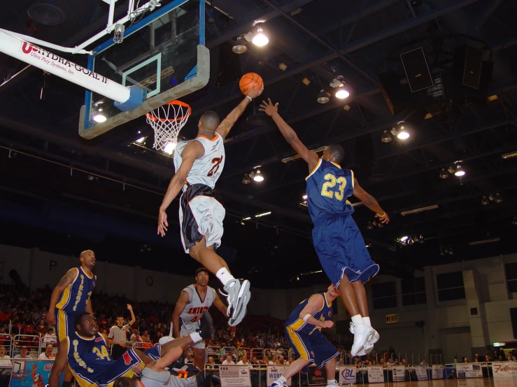 a group of men standing on a court playing basketball