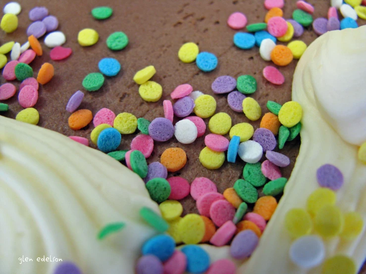 decorated cake topped with chocolate and sprinkles on a plate