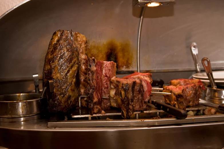 ribs being prepared on a grill in a kitchen