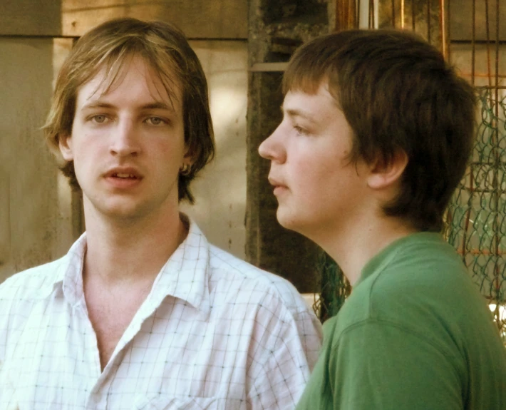 a couple of boys are standing together