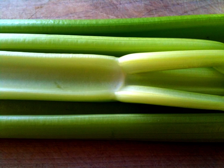 celery stalks sit next to each other on a  board