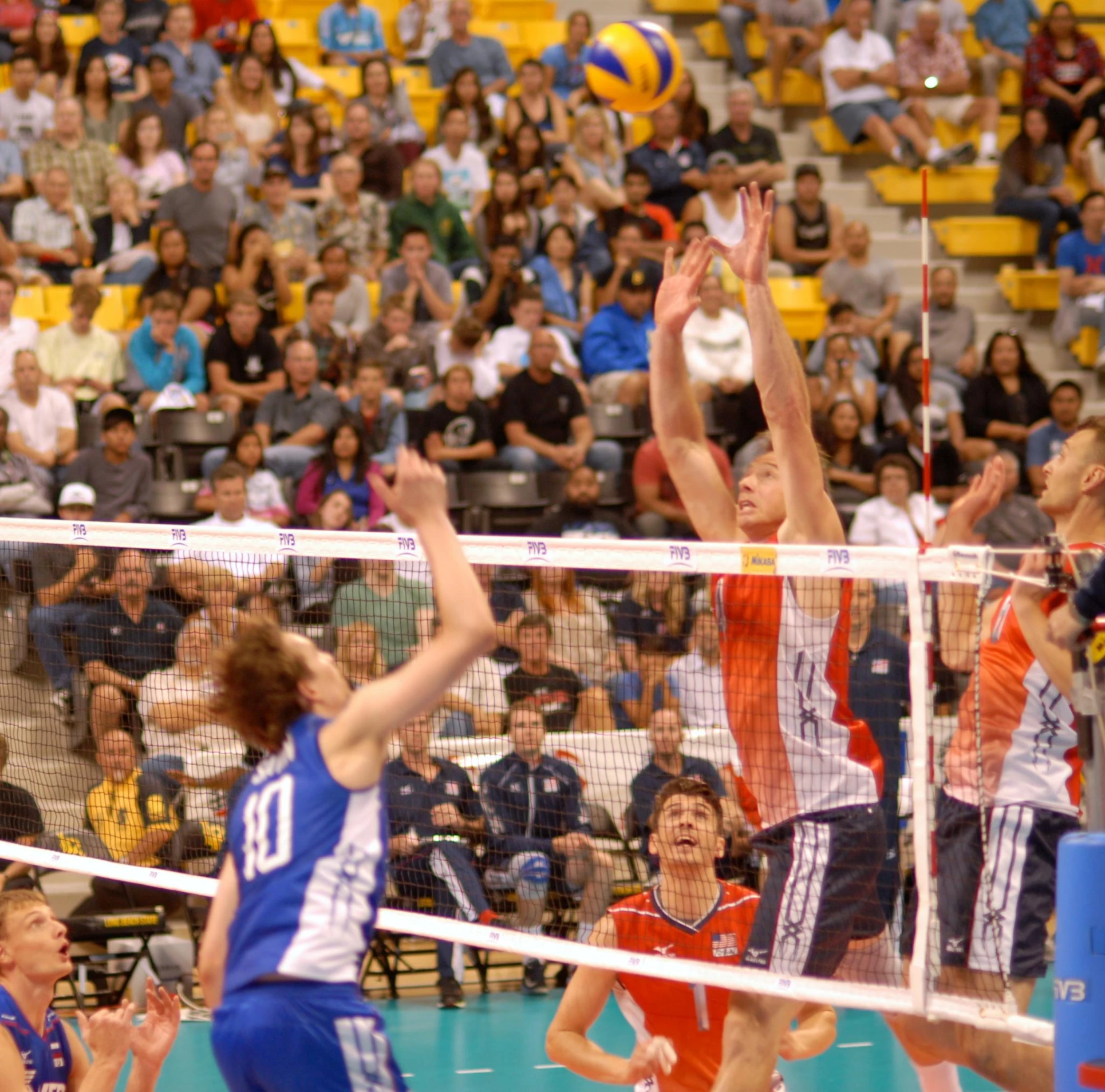 volley ball match being played on indoor court