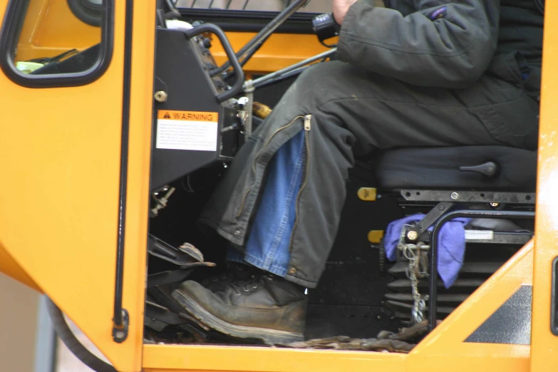 a man is sitting on the front of a bus