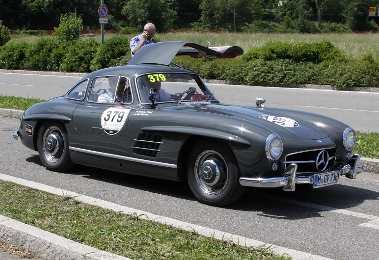 a classic sports car is carrying its surfboard on top of the top